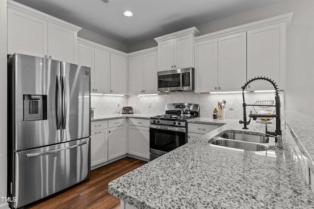 8925 Lee Brown Ridge Dr, Wake Forest, NC 27587 - kitchen featuring stainless steel appliances, a sink, white cabinetry, and recessed lighting
