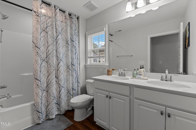 8925 Lee Brown Ridge Dr, Wake Forest, NC 27587 - bathroom with wood finished floors, toilet, double vanity, and shower / bath combination with curtain