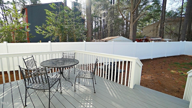 4613 Nesbit Ct, Raleigh, NC 27616 - deck with outdoor dining area and fence