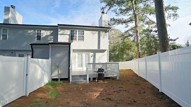 4613 Nesbit Ct, Raleigh, NC 27616 - rear view of house featuring a deck, a chimney, and a fenced backyard