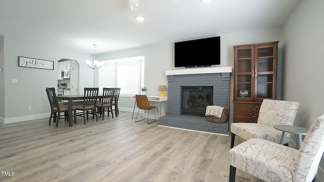 4613 Nesbit Ct, Raleigh, NC 27616 - living room featuring baseboards, a chandelier, wood finished floors, a fireplace, and recessed lighting