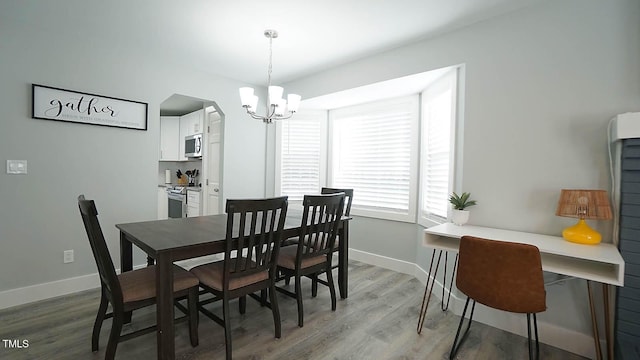 4613 Nesbit Ct, Raleigh, NC 27616 - dining space with a chandelier, light wood-style floors, and baseboards