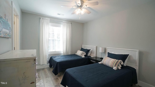 4613 Nesbit Ct, Raleigh, NC 27616 - bedroom featuring multiple windows, light wood-style flooring, and a ceiling fan