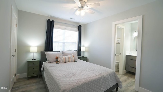 4613 Nesbit Ct, Raleigh, NC 27616 - bedroom with wood finished floors, ensuite bathroom, baseboards, and ceiling fan