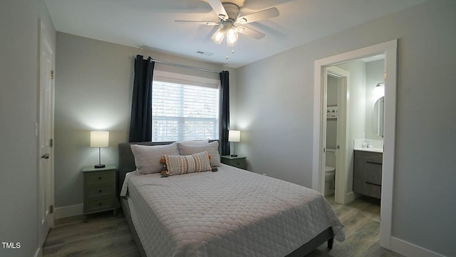 4613 Nesbit Ct, Raleigh, NC 27616 - bedroom with wood finished floors, ensuite bathroom, baseboards, and a ceiling fan