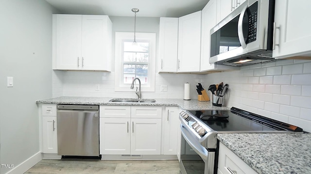 4613 Nesbit Ct, Raleigh, NC 27616 - kitchen with stainless steel appliances, a sink, and white cabinetry