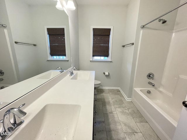 8813 Moss Glen Dr, Raleigh, NC 27617 - bathroom with toilet, shower / bath combination, double vanity, and baseboards