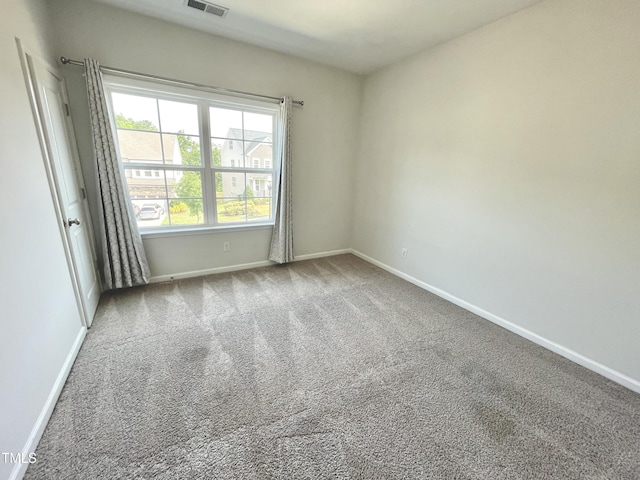 8813 Moss Glen Dr, Raleigh, NC 27617 - spare room featuring baseboards and carpet