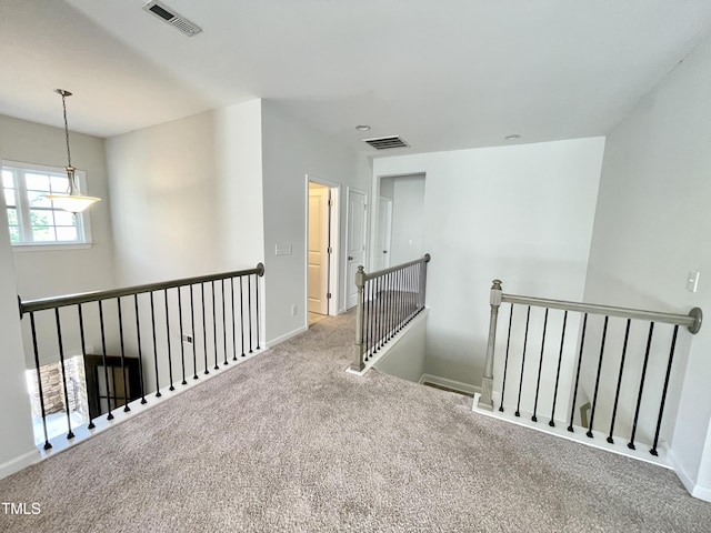 8813 Moss Glen Dr, Raleigh, NC 27617 - hall featuring an upstairs landing, carpet floors, and baseboards