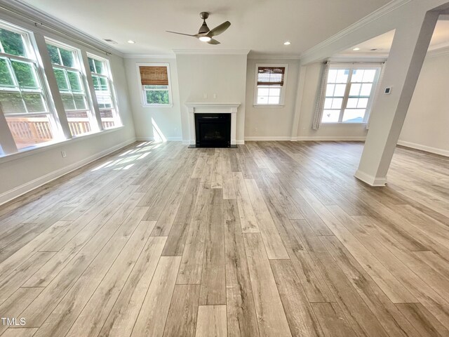 8813 Moss Glen Dr, Raleigh, NC 27617 - unfurnished living room with light wood-type flooring, ornamental molding, a ceiling fan, baseboards, and a fireplace with flush hearth