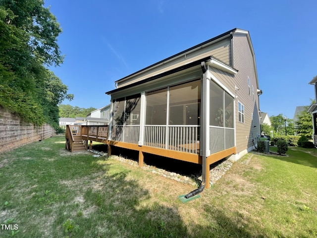 8813 Moss Glen Dr, Raleigh, NC 27617 - back of house with a sunroom, a yard, and a wooden deck
