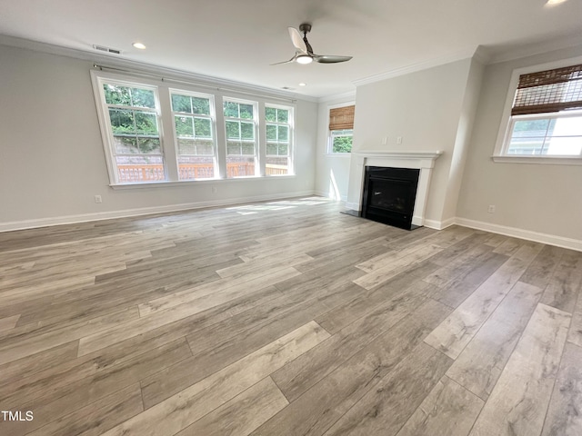 8813 Moss Glen Dr, Raleigh, NC 27617 - unfurnished living room featuring ornamental molding, a ceiling fan, light wood-style flooring, plenty of natural light, and a fireplace