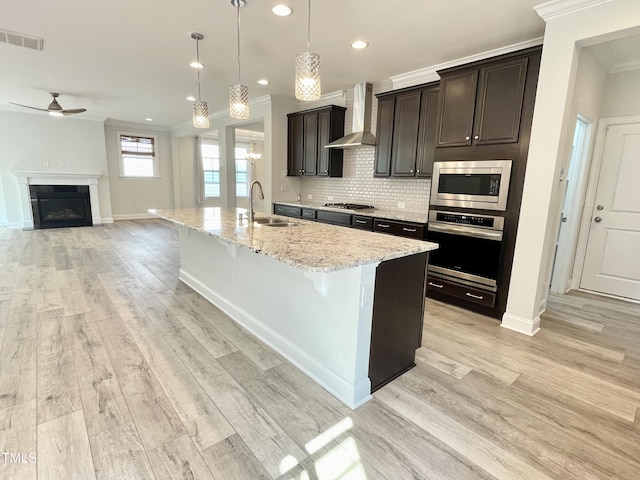 8813 Moss Glen Dr, Raleigh, NC 27617 - kitchen with appliances with stainless steel finishes, wall chimney exhaust hood, ornamental molding, ceiling fan, and recessed lighting