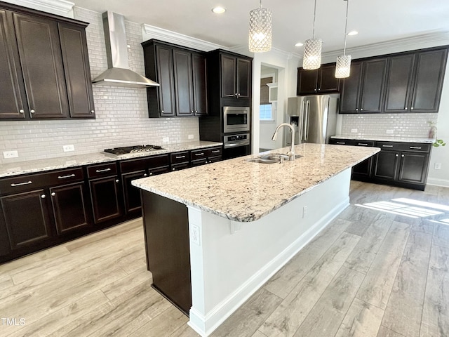 8813 Moss Glen Dr, Raleigh, NC 27617 - kitchen with appliances with stainless steel finishes, wall chimney range hood, a sink, decorative backsplash, and an island with sink