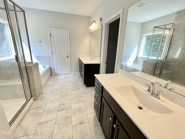 8813 Moss Glen Dr, Raleigh, NC 27617 - bathroom with two vanities, a shower stall, and a bath