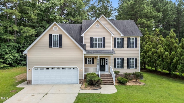 185 Keller Dr, Clayton, NC 27520 - traditional home featuring concrete driveway, an attached garage, a front lawn, covered porch, and a shingled roof