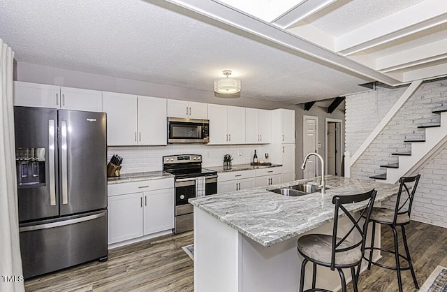 105 Litchfield Ct, Rocky Mount, NC 27803 - kitchen featuring stainless steel appliances, a sink, dark wood-type flooring, white cabinets, and light stone countertops