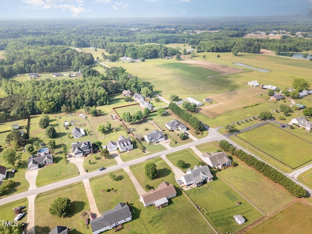 aerial overview of property's location featuring a nearby body of water and nearby suburban area