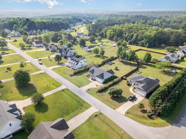 aerial view of residential area with a heavily wooded area