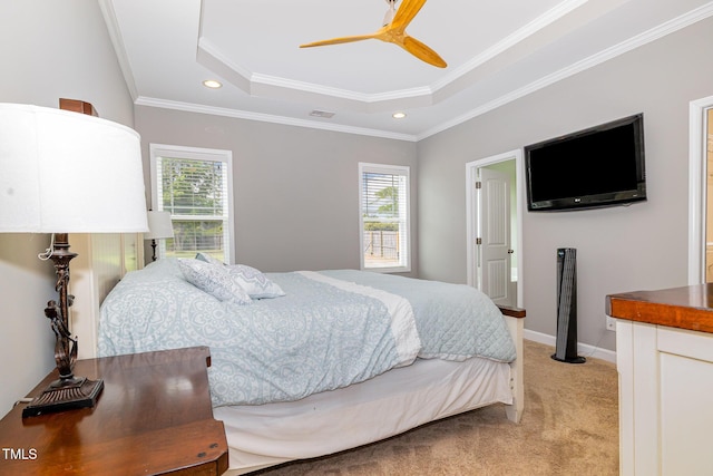 bedroom with a tray ceiling, multiple windows, light colored carpet, recessed lighting, and ornamental molding