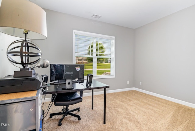 carpeted office space featuring baseboards