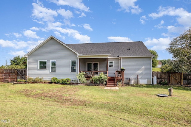 back of property with a deck and roof with shingles