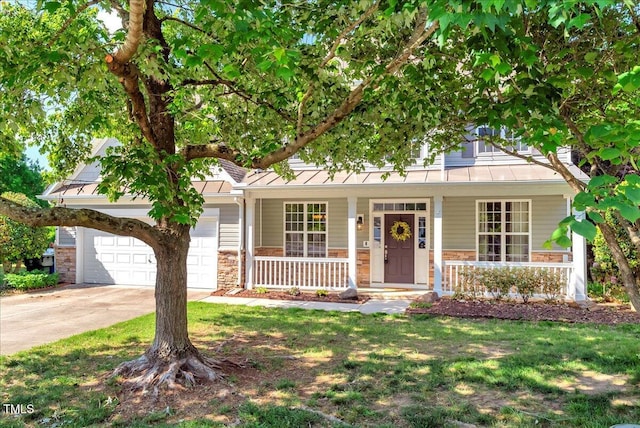 view of front of property featuring a standing seam roof, stone siding, a porch, and driveway