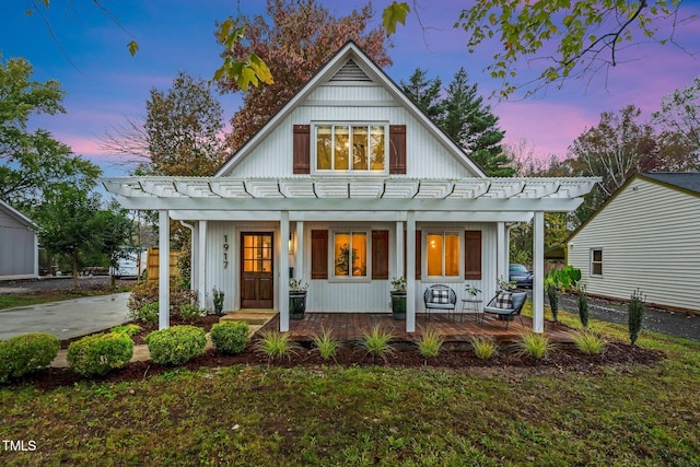 modern farmhouse featuring a porch and fence