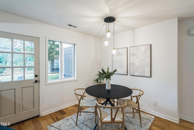 dining area with wood finished floors and baseboards
