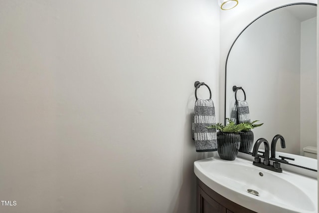 half bathroom featuring vanity