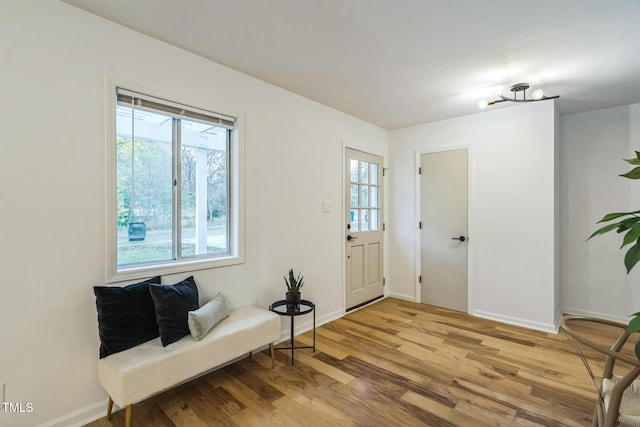 foyer with light wood-style floors and baseboards