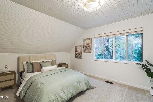 bedroom with lofted ceiling, carpet flooring, baseboards, and wood ceiling