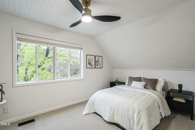 bedroom with carpet flooring, baseboards, ceiling fan, and lofted ceiling