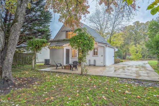 back of property featuring a patio, metal roof, and cooling unit
