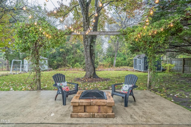 view of patio with a storage shed, an outbuilding, and an outdoor fire pit