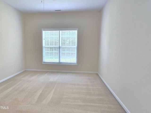 empty room with light carpet and baseboards