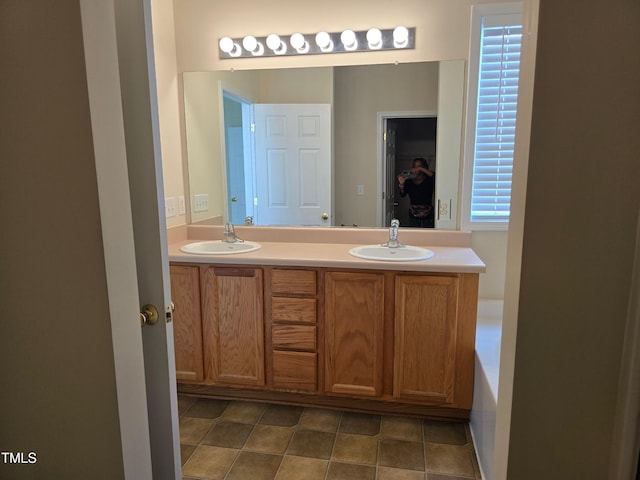bathroom with double vanity and tile patterned floors