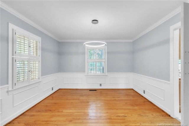 503 Charleston Pl, Fayetteville, NC 28303 - unfurnished dining area featuring light wood-style flooring, a wainscoted wall, and ornamental molding