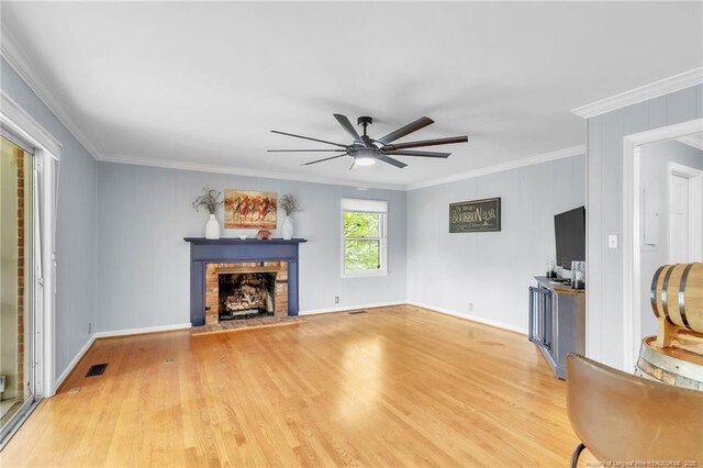 503 Charleston Pl, Fayetteville, NC 28303 - unfurnished living room featuring ceiling fan, a fireplace, crown molding, light wood-style floors, and baseboards