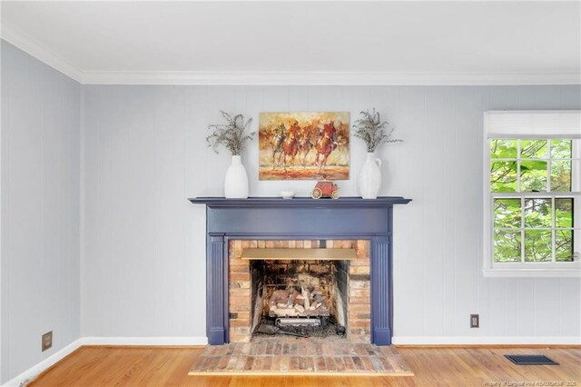 503 Charleston Pl, Fayetteville, NC 28303 - detailed view of wood finished floors, baseboards, a fireplace, and crown molding