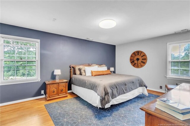 503 Charleston Pl, Fayetteville, NC 28303 - bedroom featuring multiple windows, wood finished floors, and baseboards