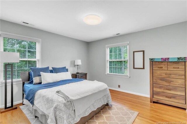 503 Charleston Pl, Fayetteville, NC 28303 - bedroom with multiple windows, light wood-type flooring, and baseboards
