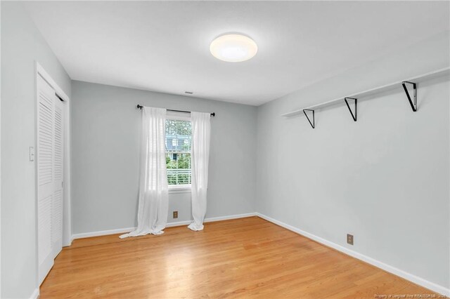 503 Charleston Pl, Fayetteville, NC 28303 - unfurnished bedroom with light wood-style flooring, baseboards, and a closet
