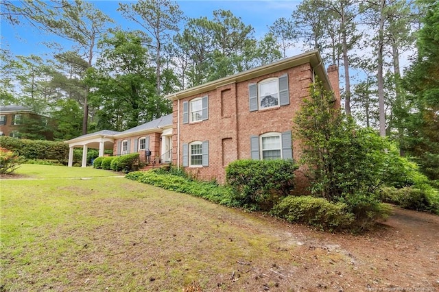 503 Charleston Pl, Fayetteville, NC 28303 - view of front of home with a chimney, a front yard, and brick siding