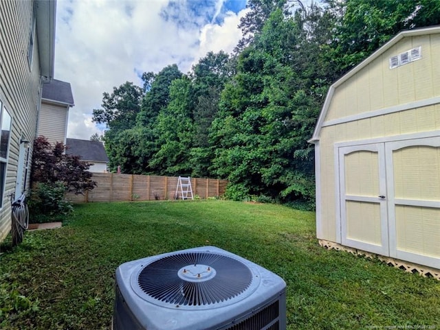view of yard with central AC unit, an outdoor structure, and a shed
