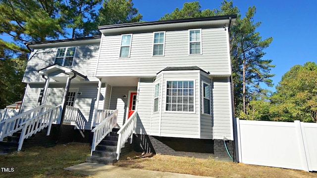 view of front facade featuring fence