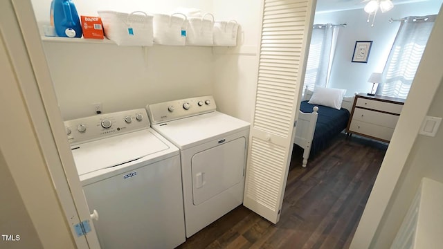 laundry room featuring washing machine and clothes dryer and dark wood finished floors