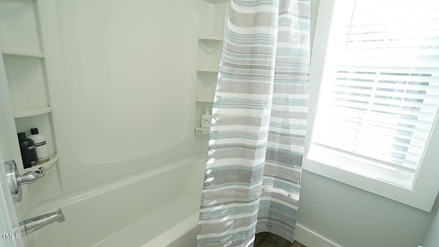 bathroom with plenty of natural light and curtained shower