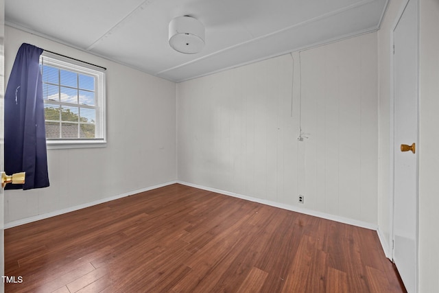 303 N Watauga Ave, Dunn, NC 28334 - spare room with wood finished floors and baseboards