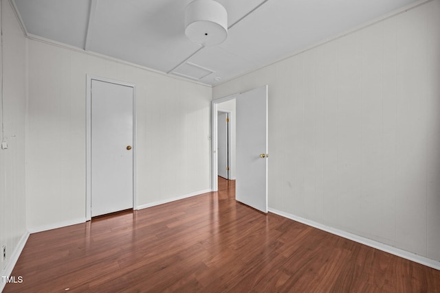 303 N Watauga Ave, Dunn, NC 28334 - unfurnished bedroom featuring attic access and wood finished floors